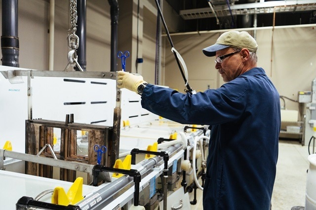 Nel Hydrogen test engineer washes machine parts.