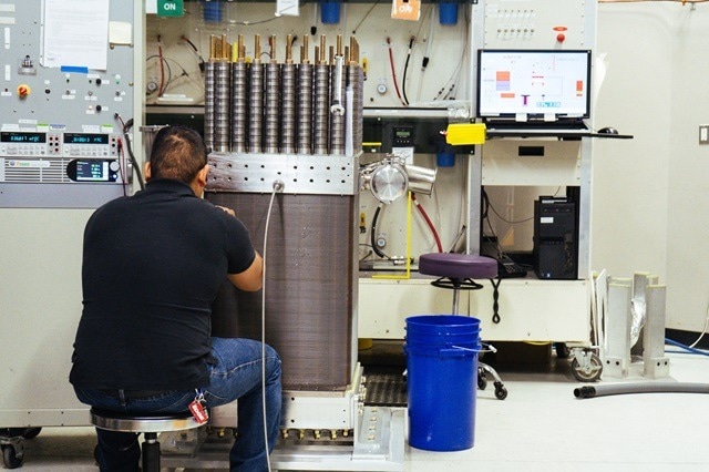 Nel Hydrogen engineer works on a PEM electrolyzer.
