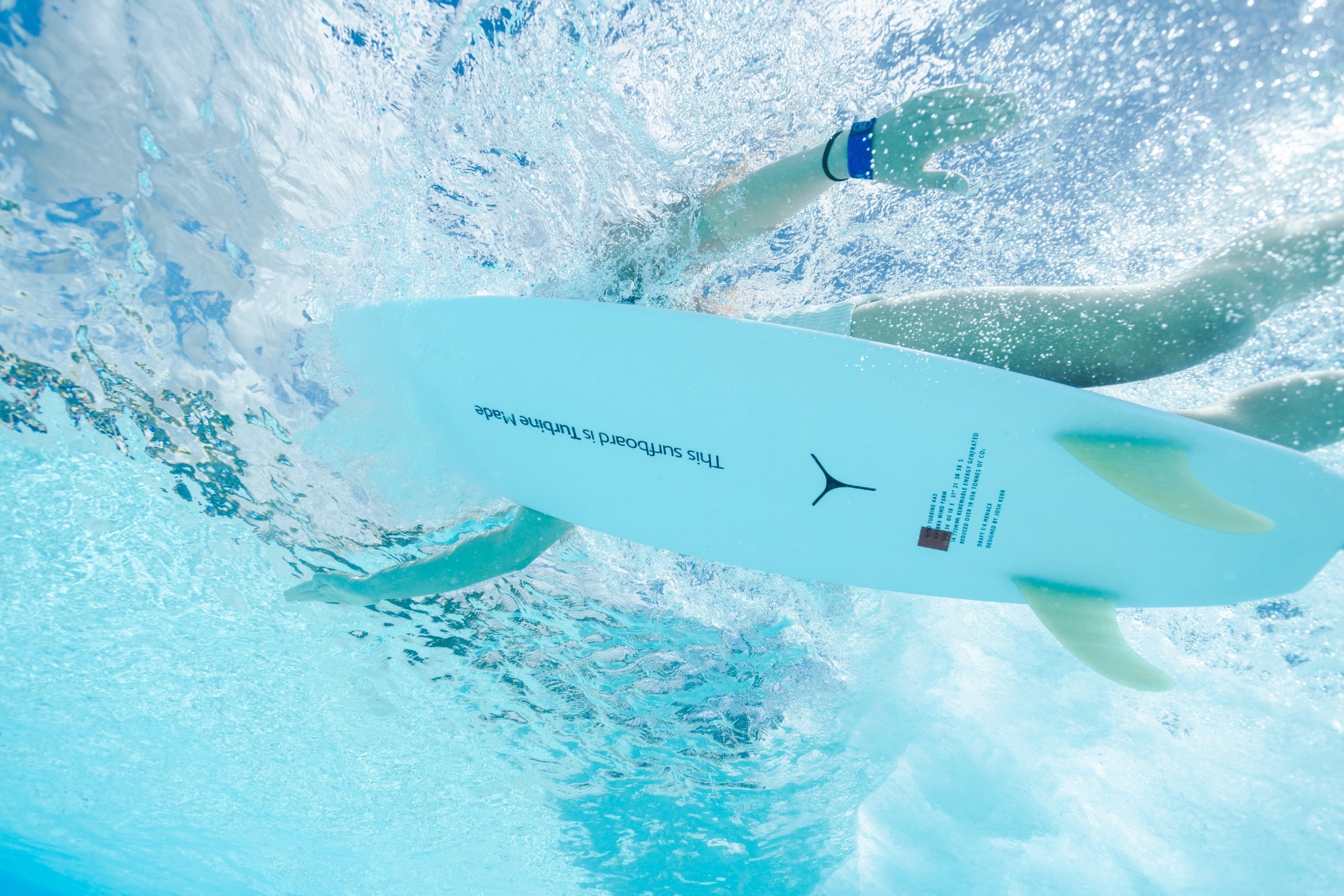 woman surfing with turbine made surfboard