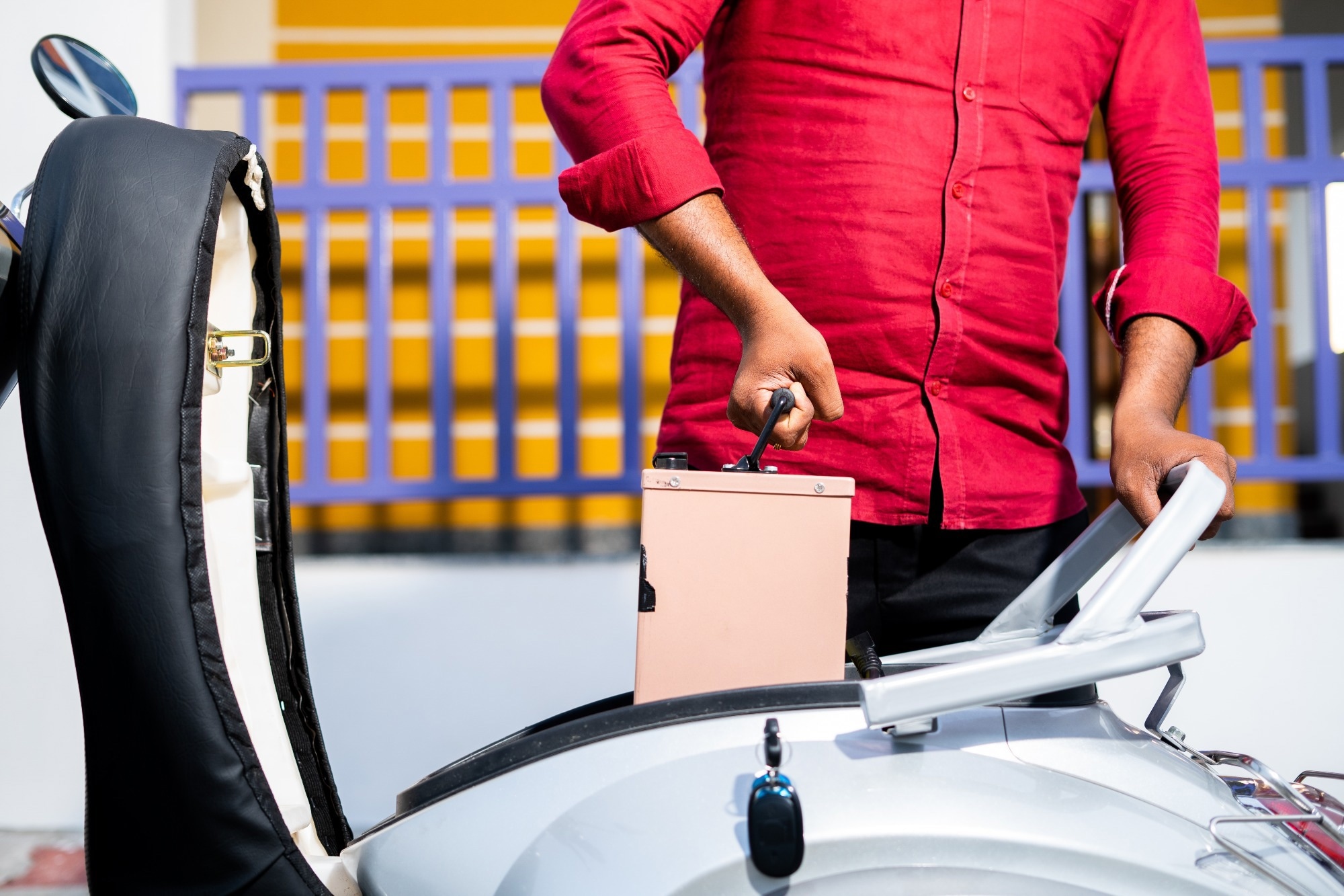 man replacing battery in electric vehicle