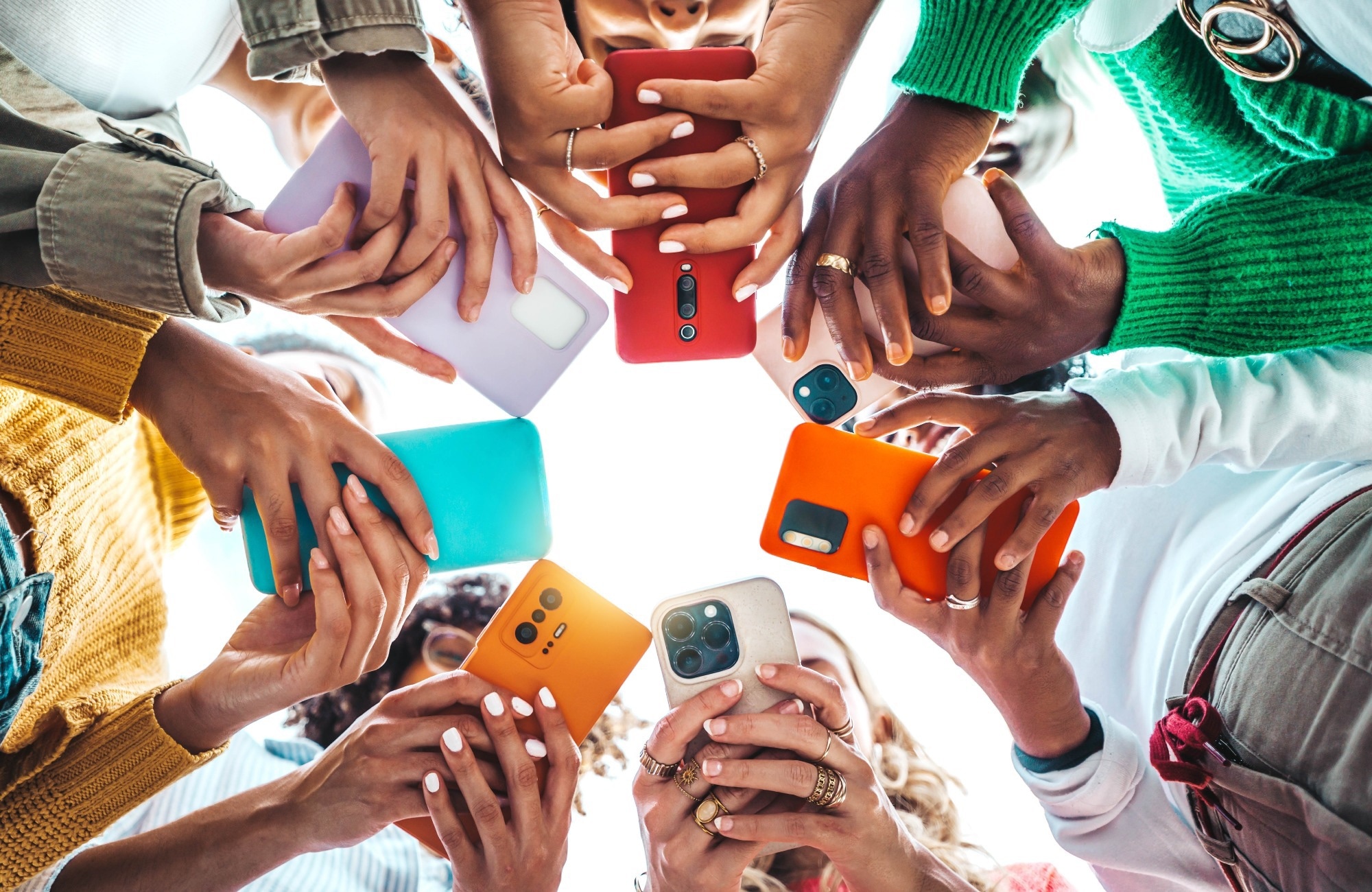 mobile phones being held by group of people