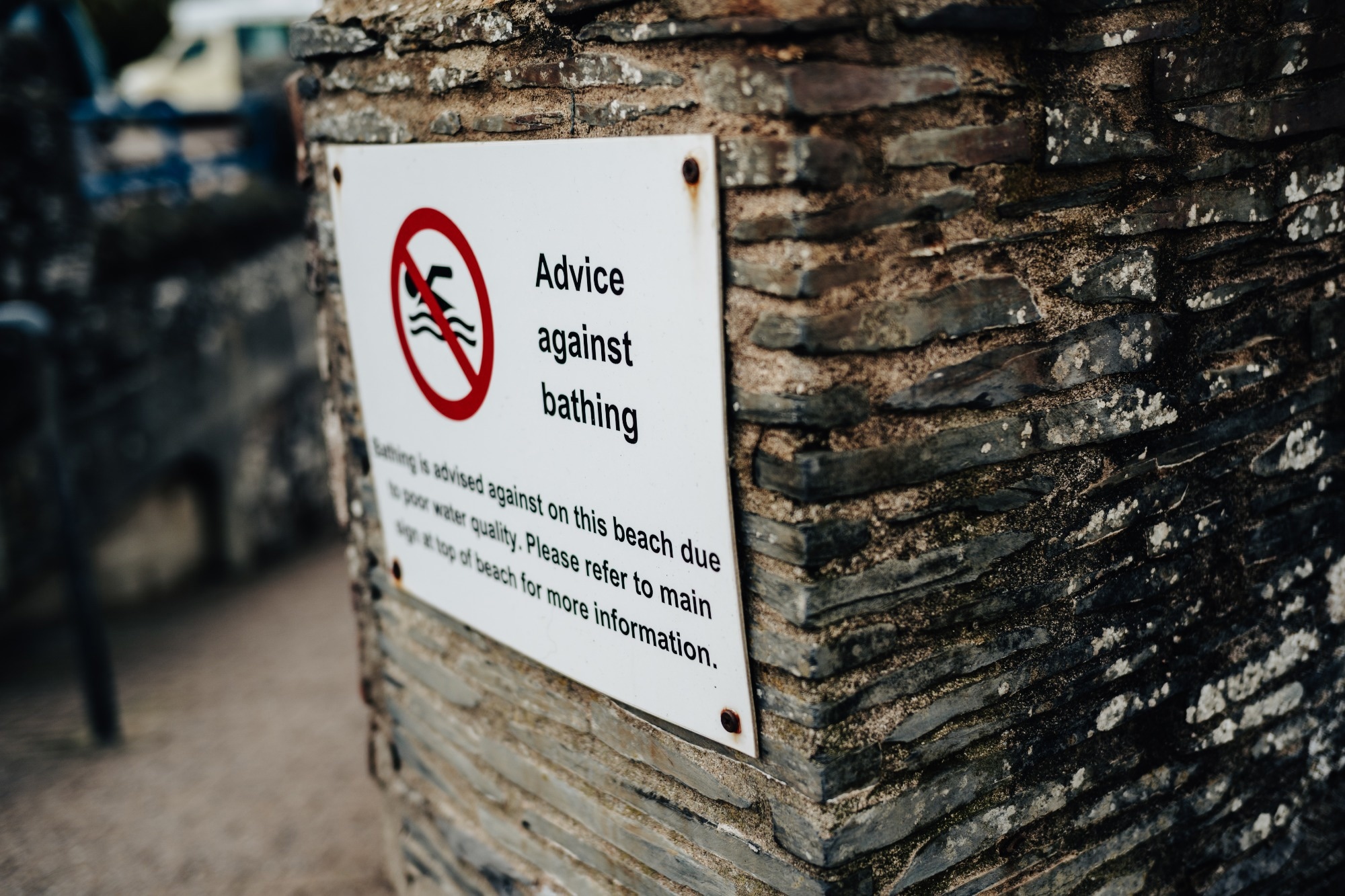 sewage, sign warning not to swim at beach