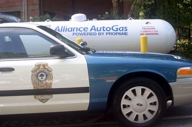 An autogas cruiser from the Raleigh, N.C., Police Department in front of an Alliance AutoGas fuel tank.