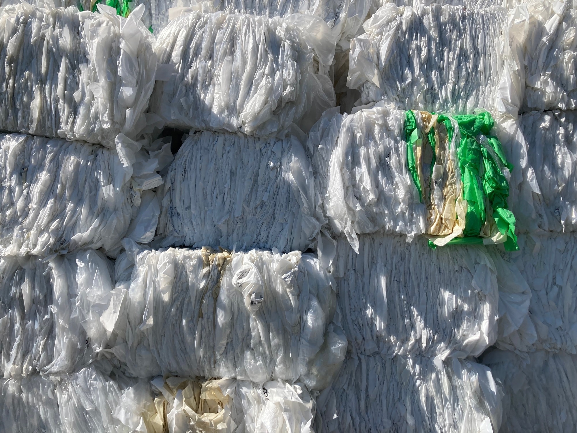Plastic film bales stored for recycling.