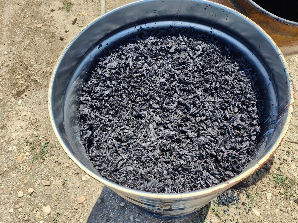 biochar in an oil drum
