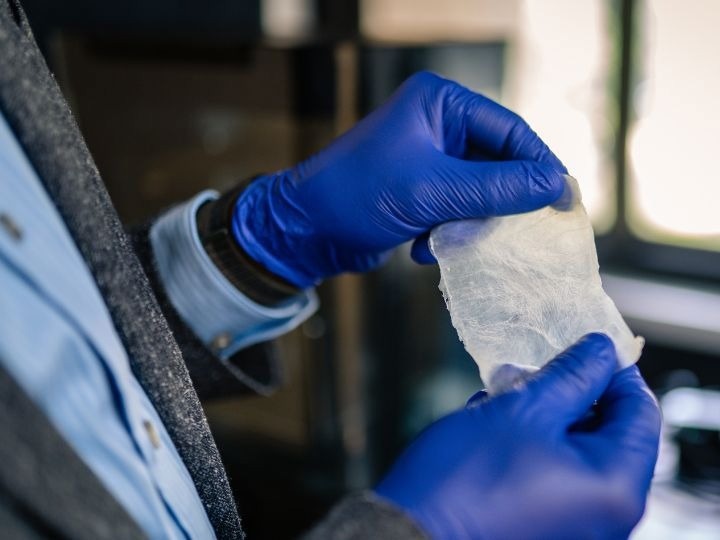 Photo of Rahman holding the bioplastic