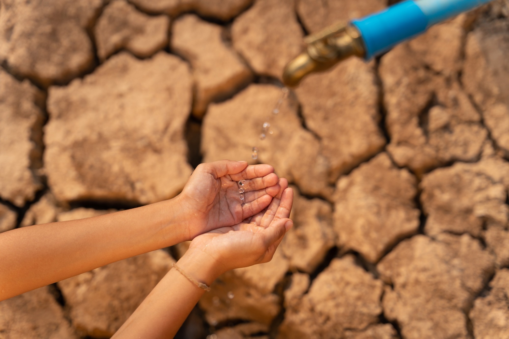 hand waiting for water from pipe