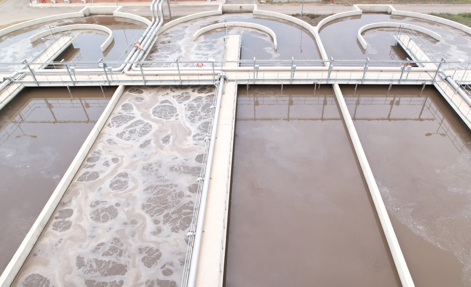 An image of a sewage waste water treatment plant with one section of water being treated.