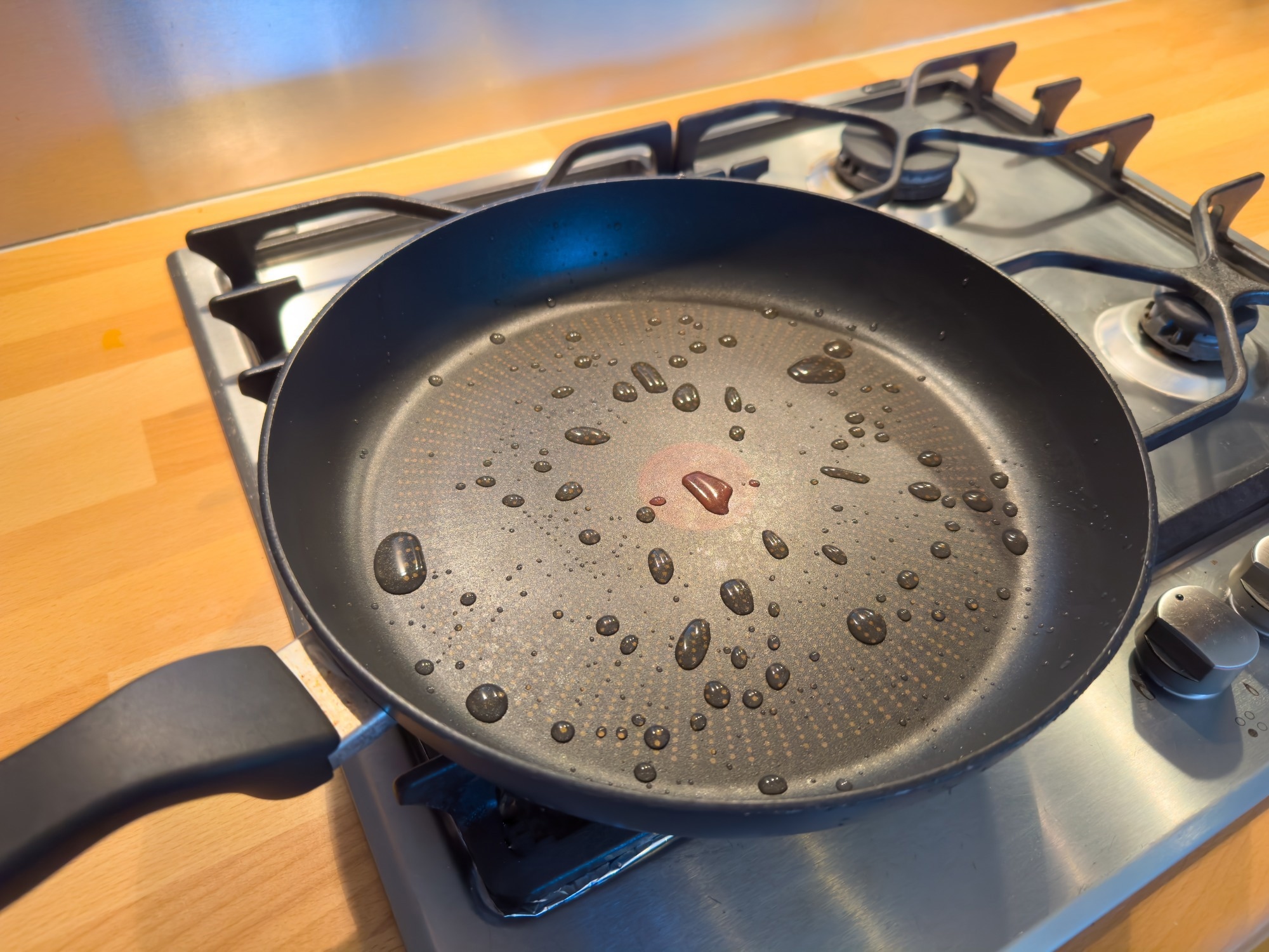 a black non-stick frying pan on a cooking hob