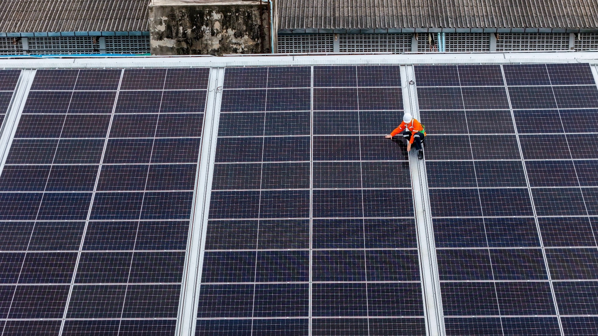man on top of solar panel from above