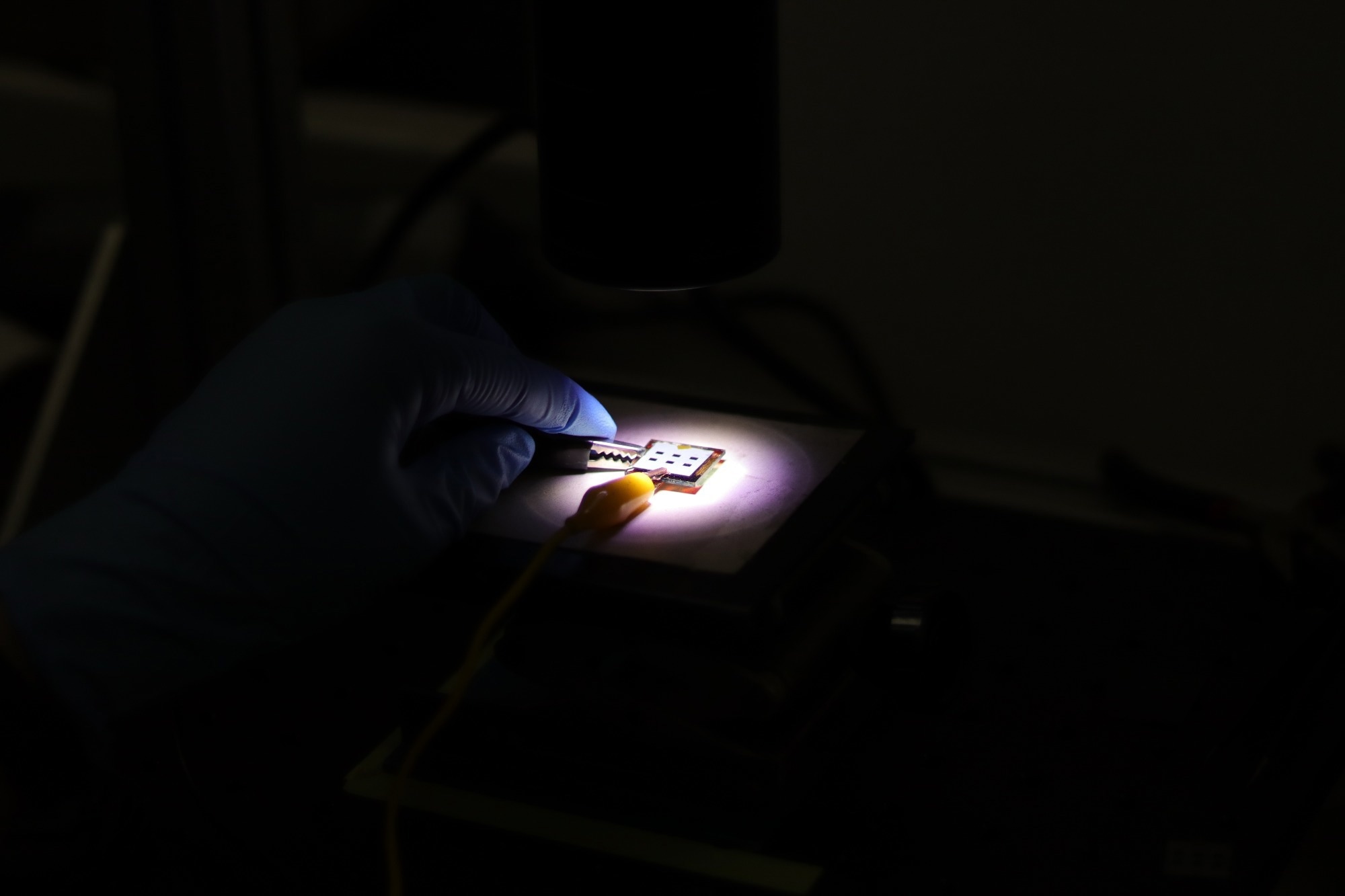 researcher looking at perovskite solar cells in lab